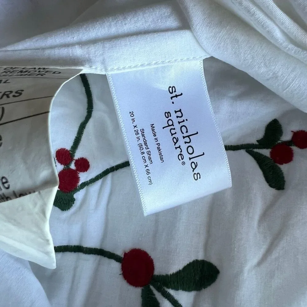 St. Nicholas Square Christmas pillow cases featuring embroidered trailing green